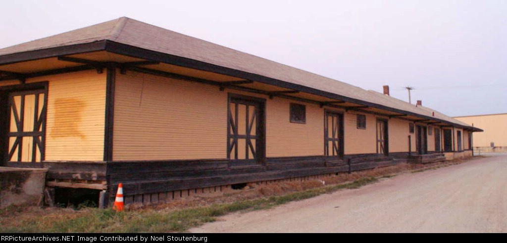 West end of South wall of depot.