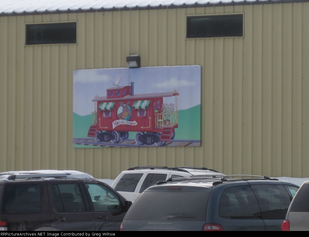 The painting of a caboose is seen on the side of the YMCA building