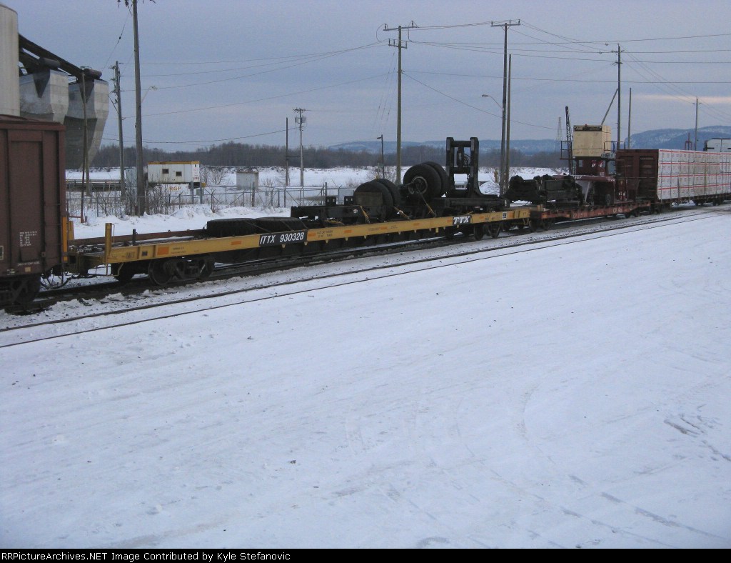 A coupple interesting flat car loads. I think its a intermodel stack loader?