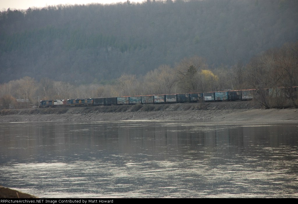 The same road freight heads west in a long view.