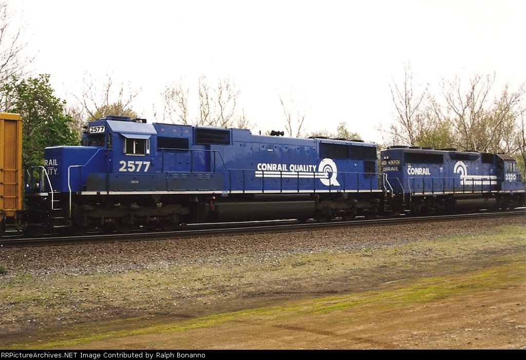 starting to show its road grime, SD70 2577 and GP40-2 3320 roll east through CP-BURN