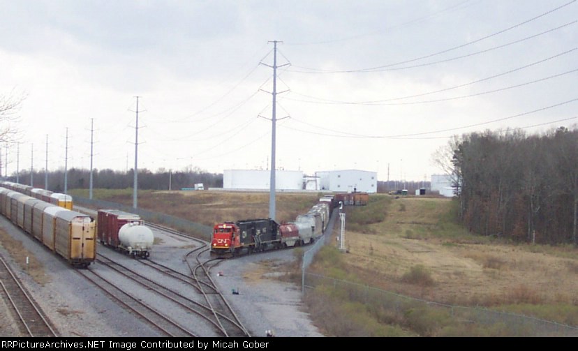 The CN/IC train at the Nissan Auto Plant.  There was a severe thunder storm off in the back ground.  