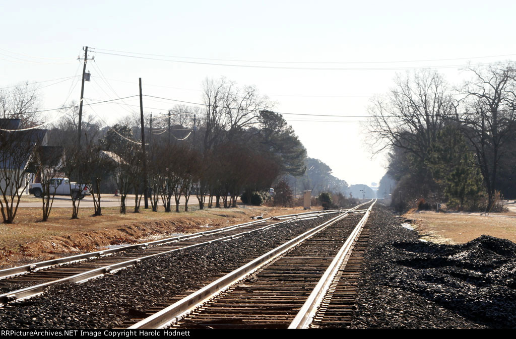 Old jointed rail siding contrasts with heavy CWR main