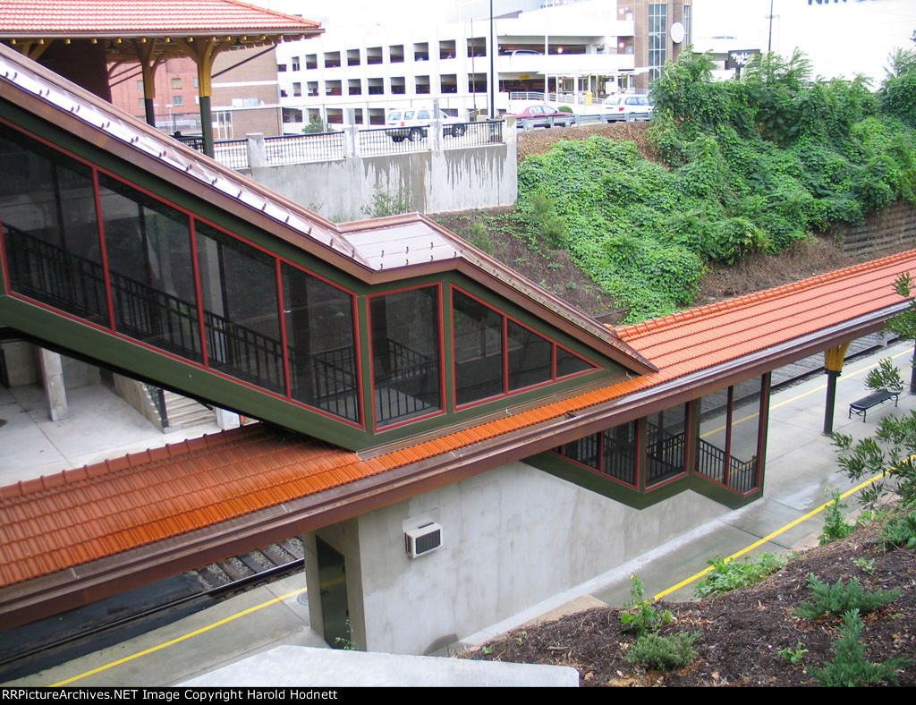 Covered, enclosed staircases to lower passenger platform and tracks
