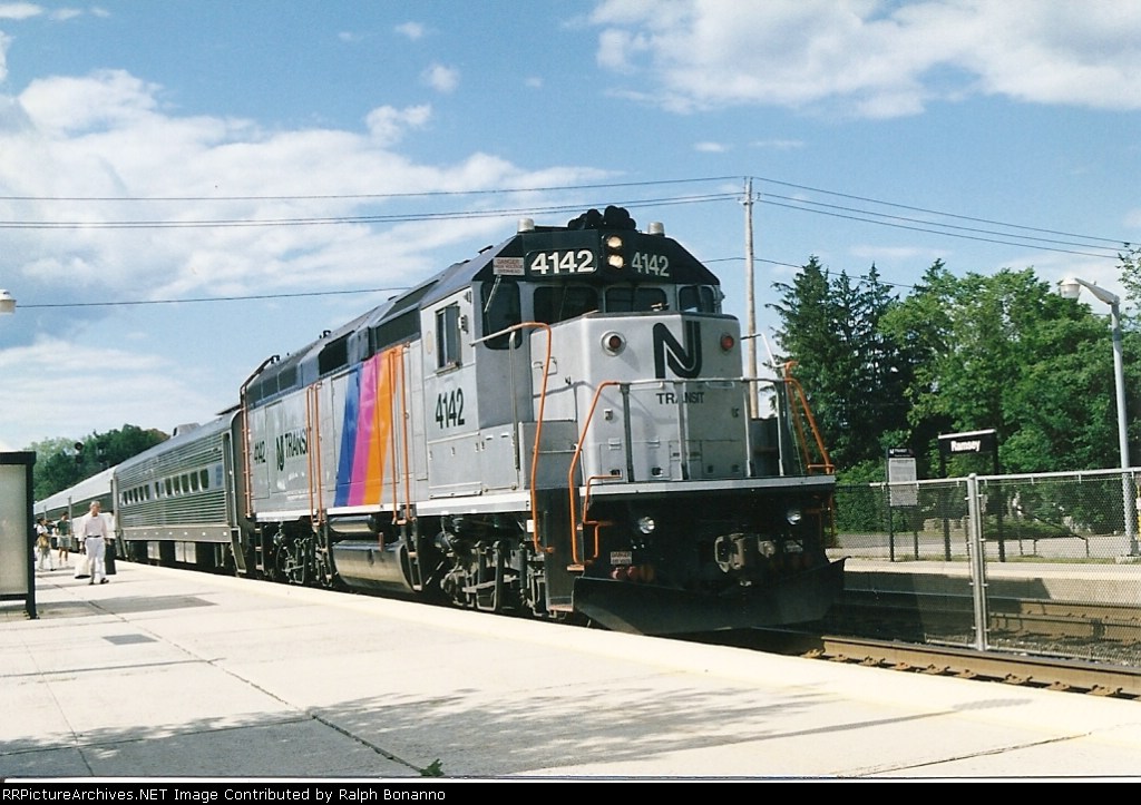 A mid day local on the Main Line makes a stop at the Main St station