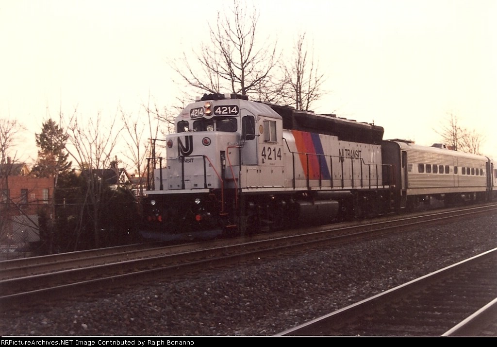 4214 accelerates from the station with a typical NJT evening rush commuter train