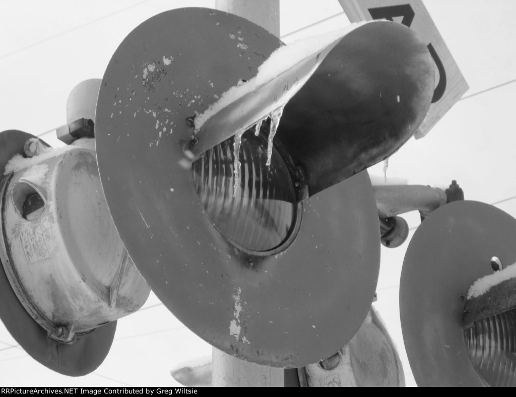 Ice hangs from crossing lights