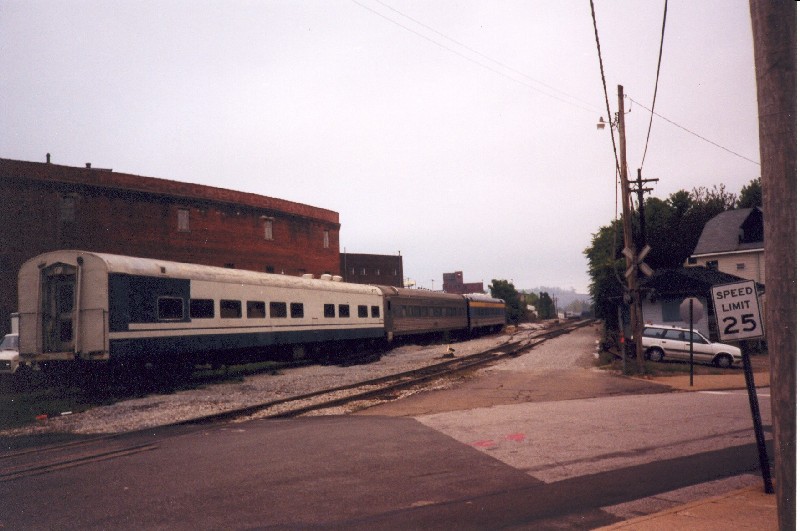 3 old Passanger cars sitting between the small yard and the bridge across the Ohio river