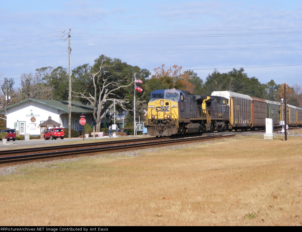 A Wider View of CSX 100 leading an Autorack Train through town