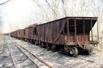 A string of EBT hoppers sit where they were left almost 50 years ago.  Note the second car has the extended sides to increase the capacity of the car.