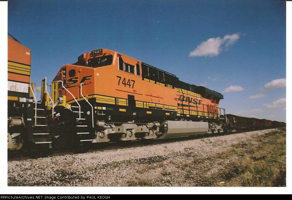 BNSF 7447 glistens in the Nebraska sun as a 3rd unit on a westbound manifest train.