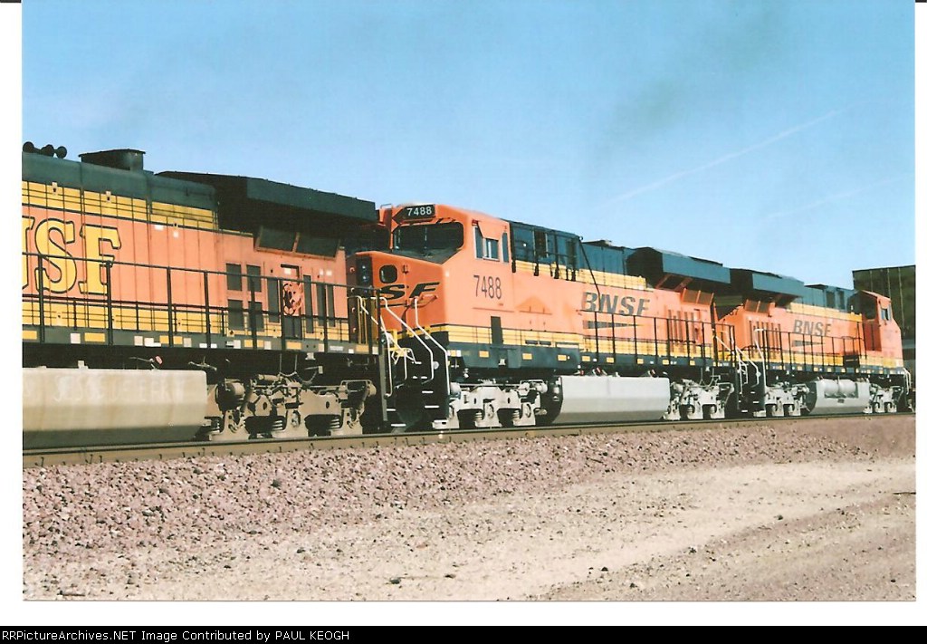 BNSF 7488 and BNSF 7487 two sisters together roll west towards BNSF Barstow.