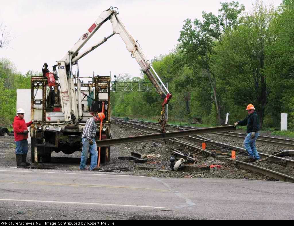 Replacement rail section is swung into plaae