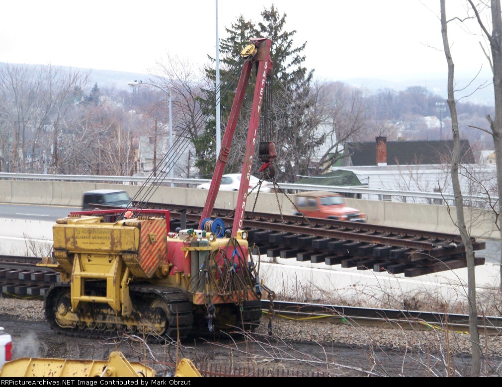 RJ Corman carrying section of track at derailment