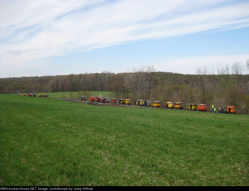 The line of speeders pause in a field