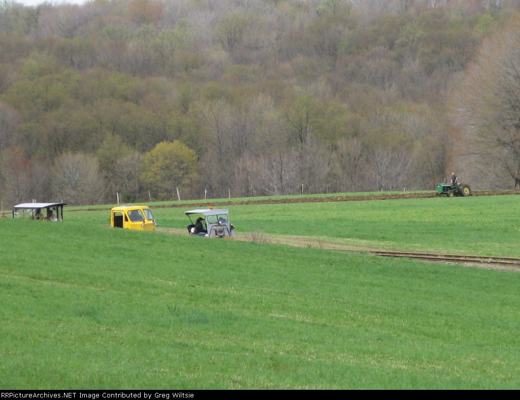 Some of the cars start to peek their way from around a hill