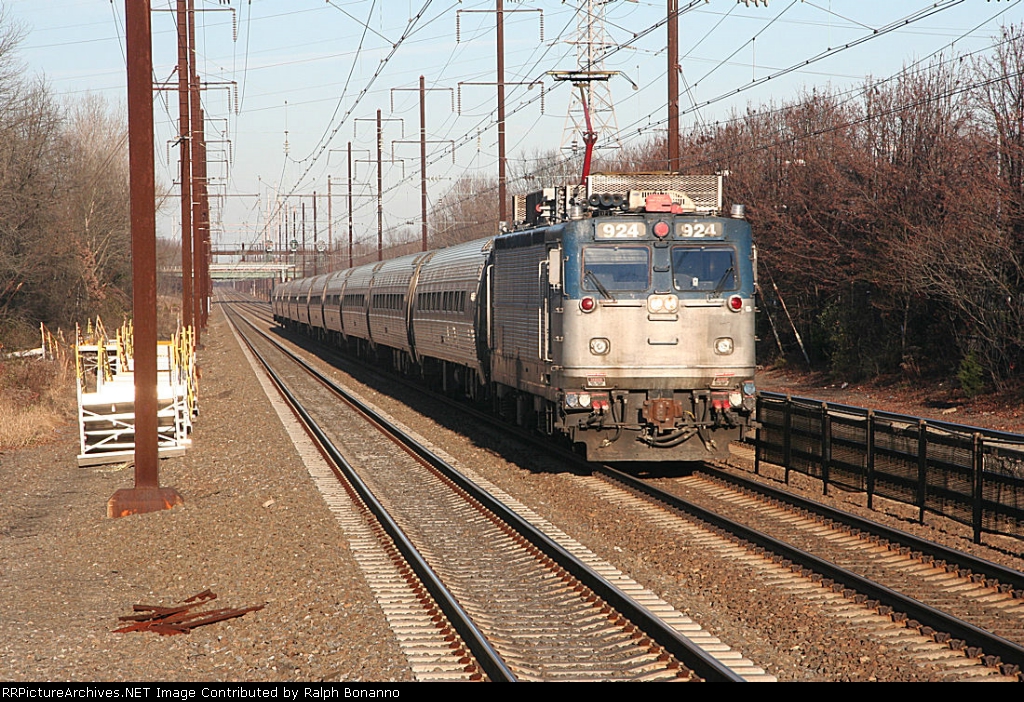 One of many Amtrak Regional trains   heads south  with a lonbger than usual consist account the thanksgiving holiday weekend