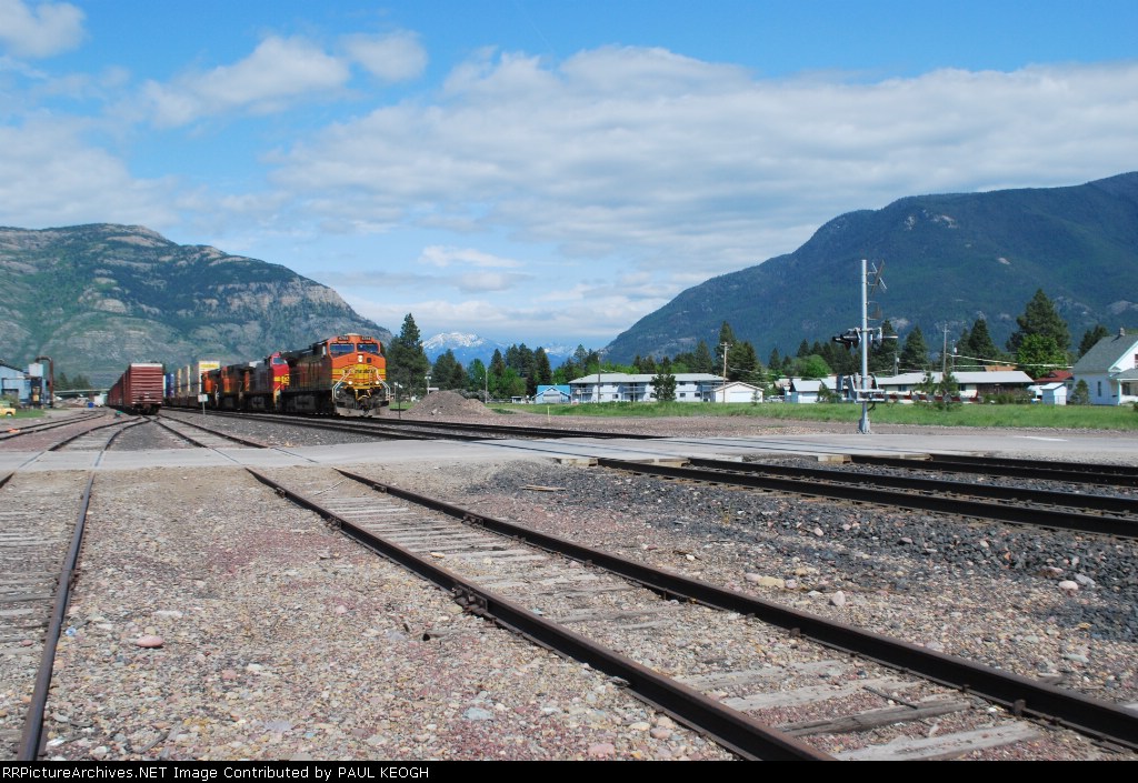 With Glacier National Park in the background BNSF 4784 rolls west towards Whitefish, Mt.