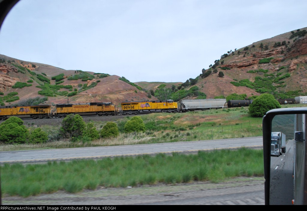UP 7415 rolls west as a #3 unit on a manifest train.