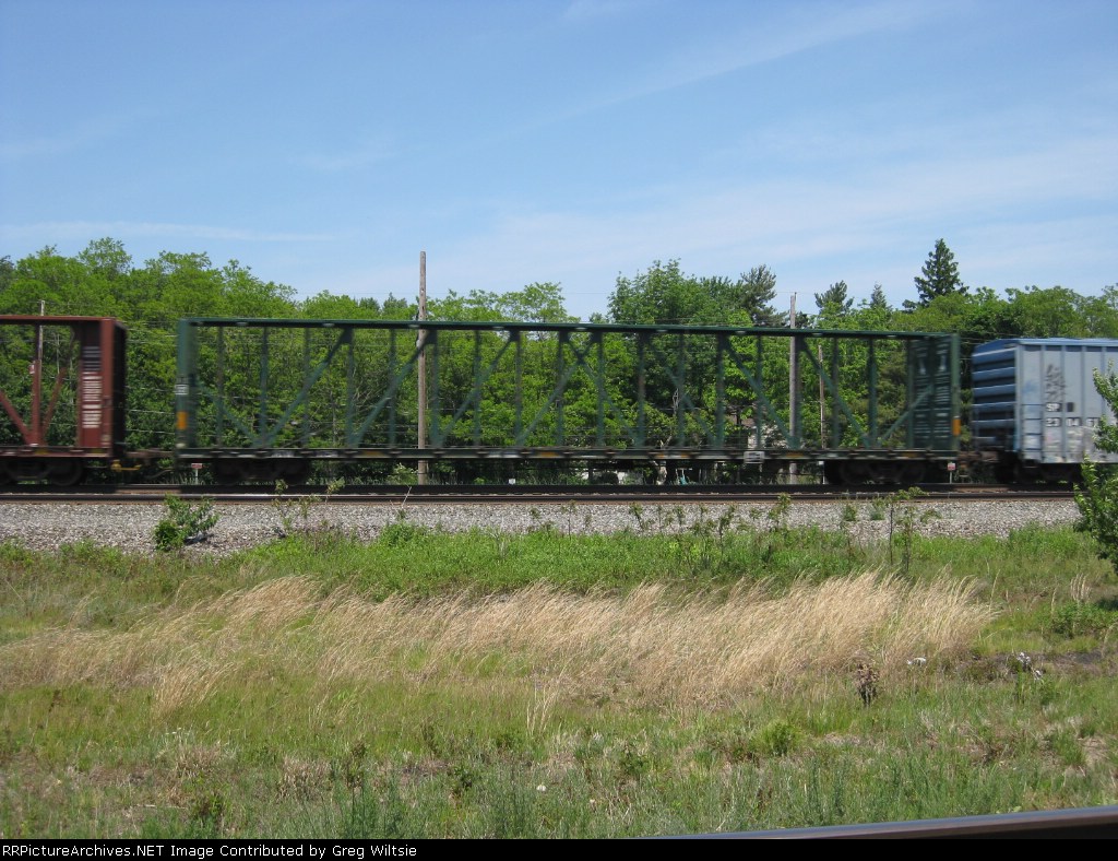 A centerbeam flatcar from an unknown owner