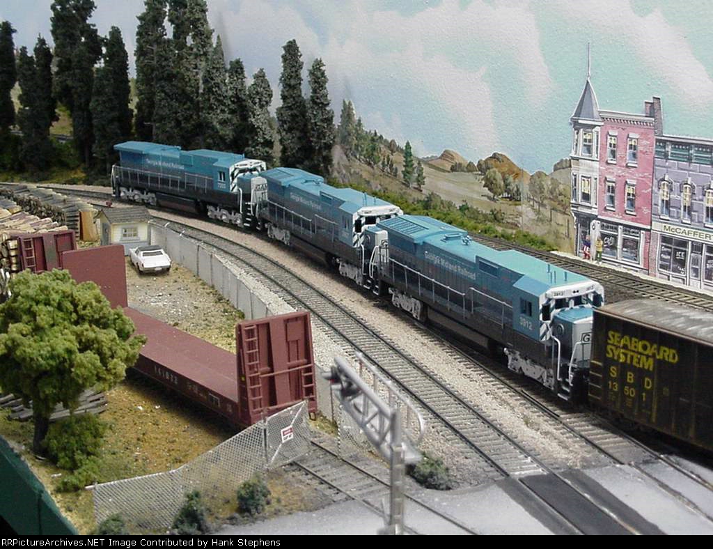 Picture Eight-- Three Georgia Midland RR GE units detour through Opelika running long hood forward in a feigned tribute to the old Southern.  In reality, the detours of the day have managers scrambling and a failed lead unit had to be set out in Columbus 