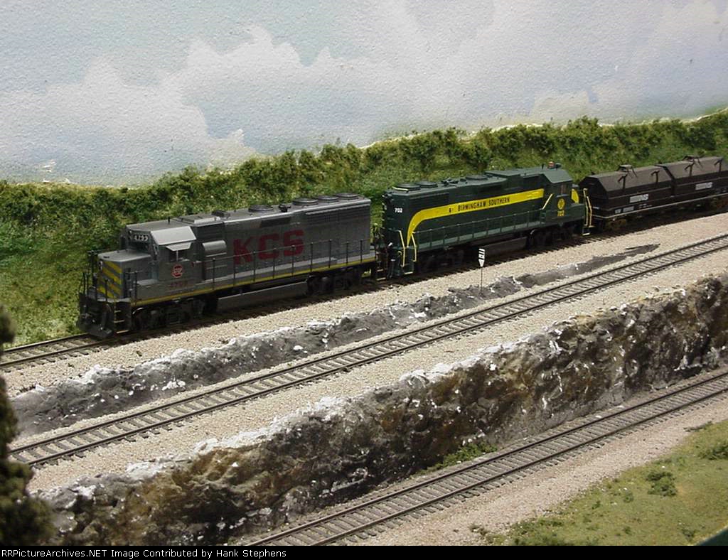 A borrowed KCS Geep pulls a BS counterpart on a NS local headed toward Macon at Muscogee Jct.  The BS unit is headed to a south Georgia contract shop for a primemover changeout.