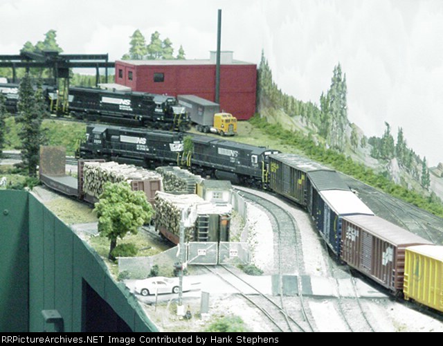 NS Road train circles around Langley woodyard on the main as Lafayette local waits in the background on the old Roanoke Branch 