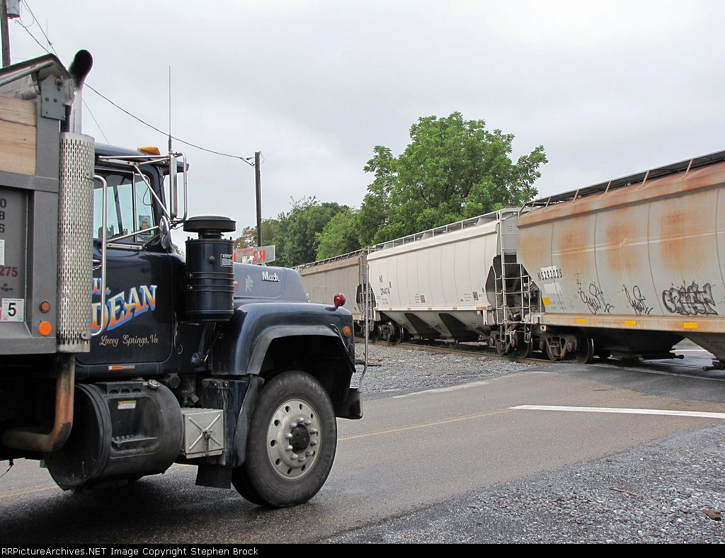 A gravel truck is held up as the grain comes through