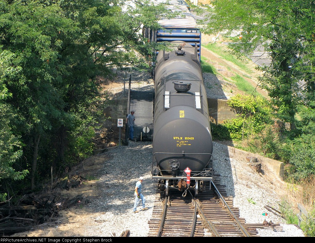 With rfdio in hand the V92 conductor watches as the last car clears the switch