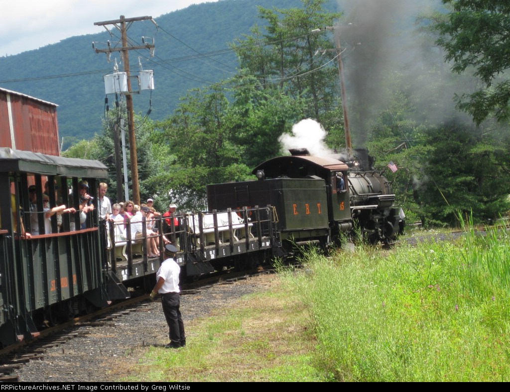 The conductor looks on as the train passes