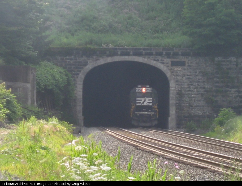The set of helpers disappear into the tunnel