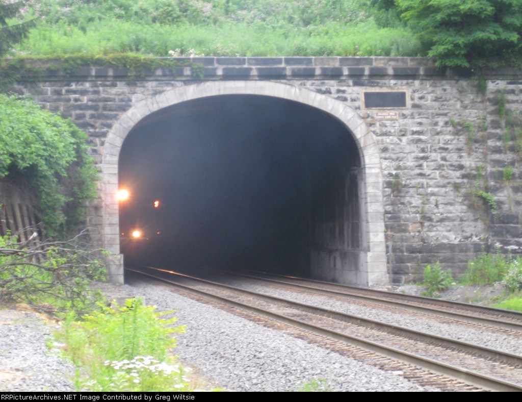 Headlights pass in the darkness of the tunnel