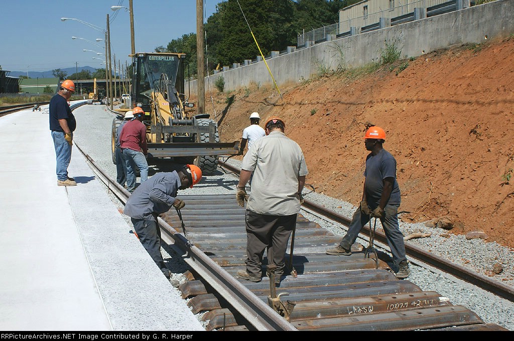 126 - These guys are earning every dime they make today laying track at Kemper Street station