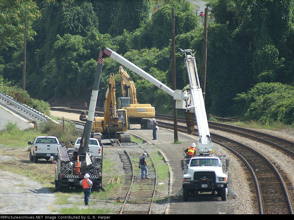 Three crews at work: the concrete crusher3 the track dismantler and the pole remover at Kemper St. Station