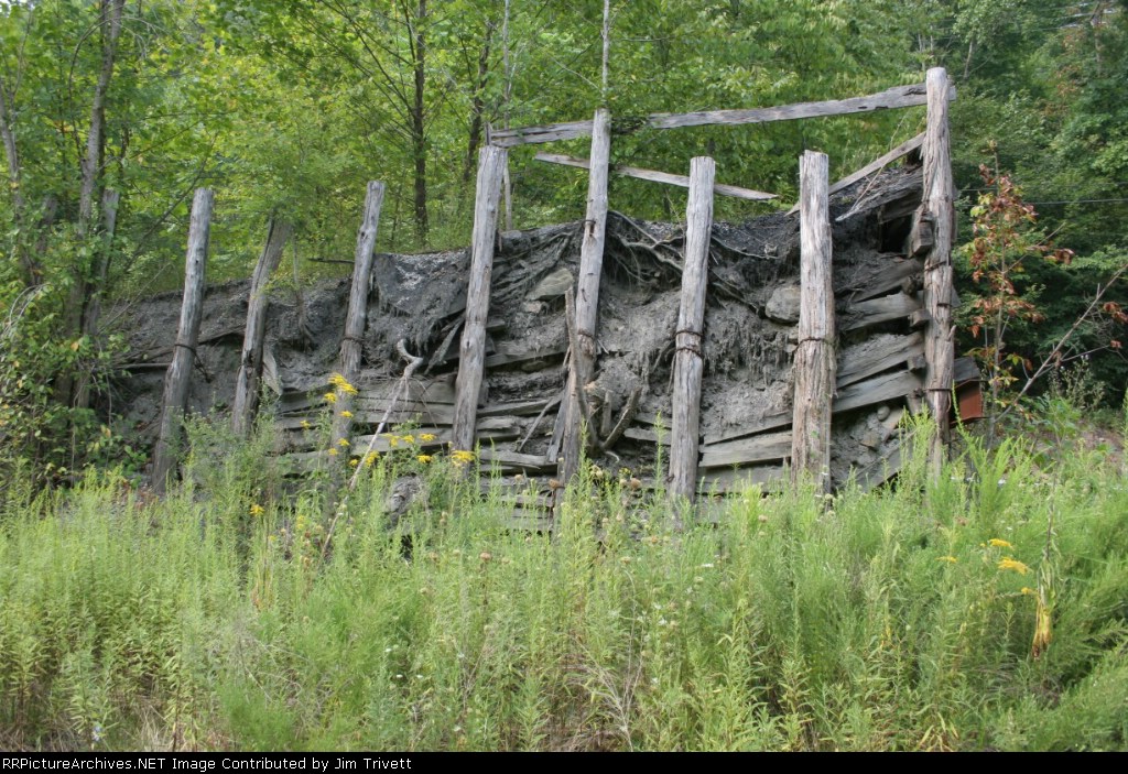 interesting construction of old rammed earth truck dump, note cables and chain holding sides together