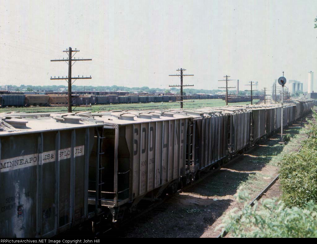 1014-16 Westbound C&NW freight passes MILW Bass Lake Yard