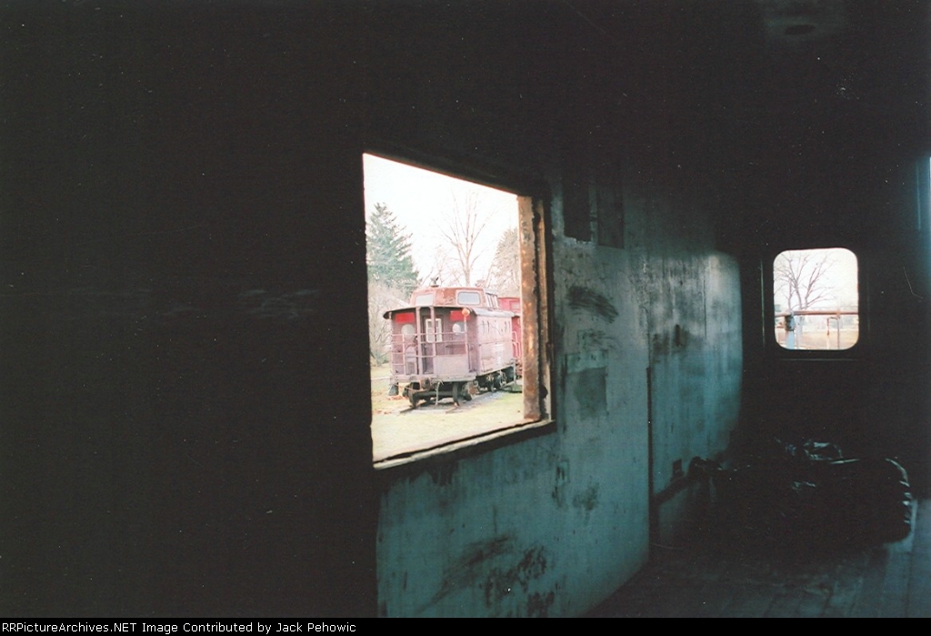 Looking out of a "cheesebox" caboose window at another