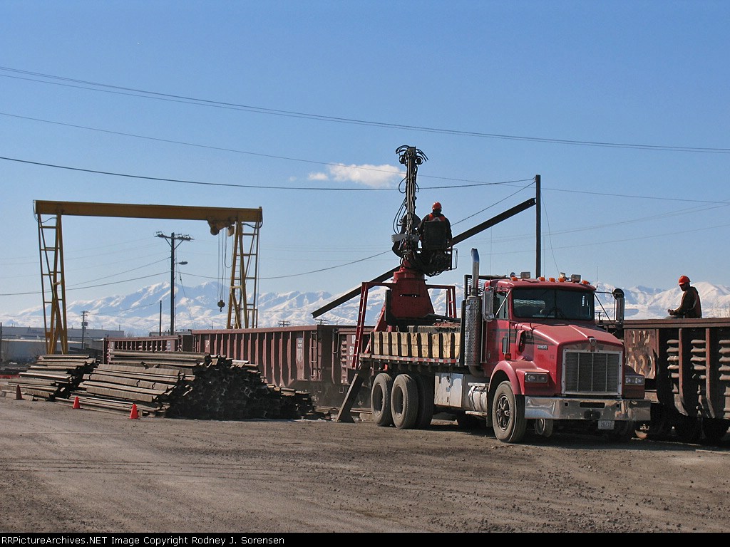 Old style rail segments being loaded into gondolas