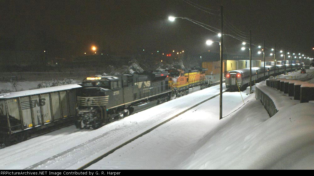 NS train 228 with BNSF power passes NS 88M and the Lynchburg NEC regional train