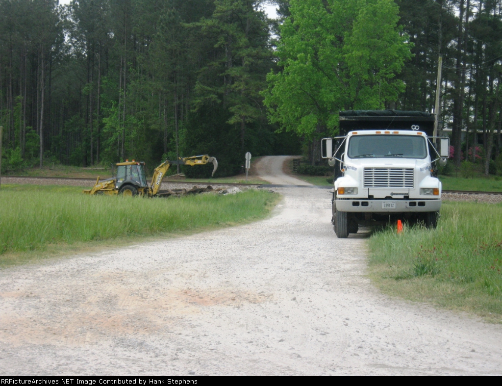 CSX local MofW worker clears debris from a newly replaced crossing at Cusset, AL 