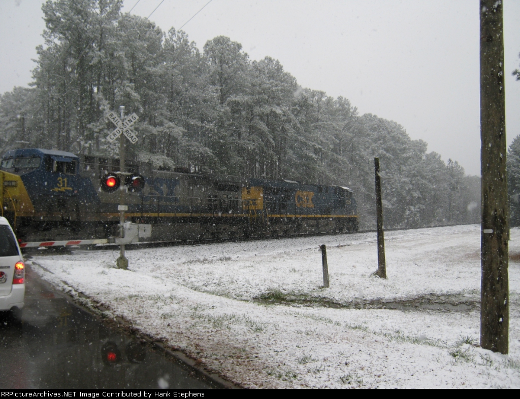 CSX Q615 pulls through crossing as it pulls outbound cars at LaGrange