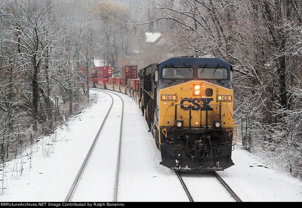 Northbound Q161 rolls by on the main, in fresh snow, north of CP 562 on the River Line