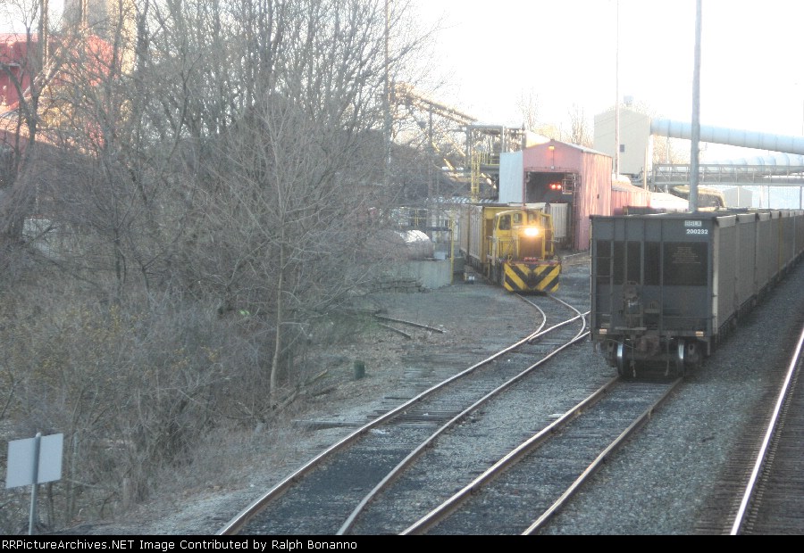 The 110 ton GE owned by the power plant goes about moving cars through the unloader