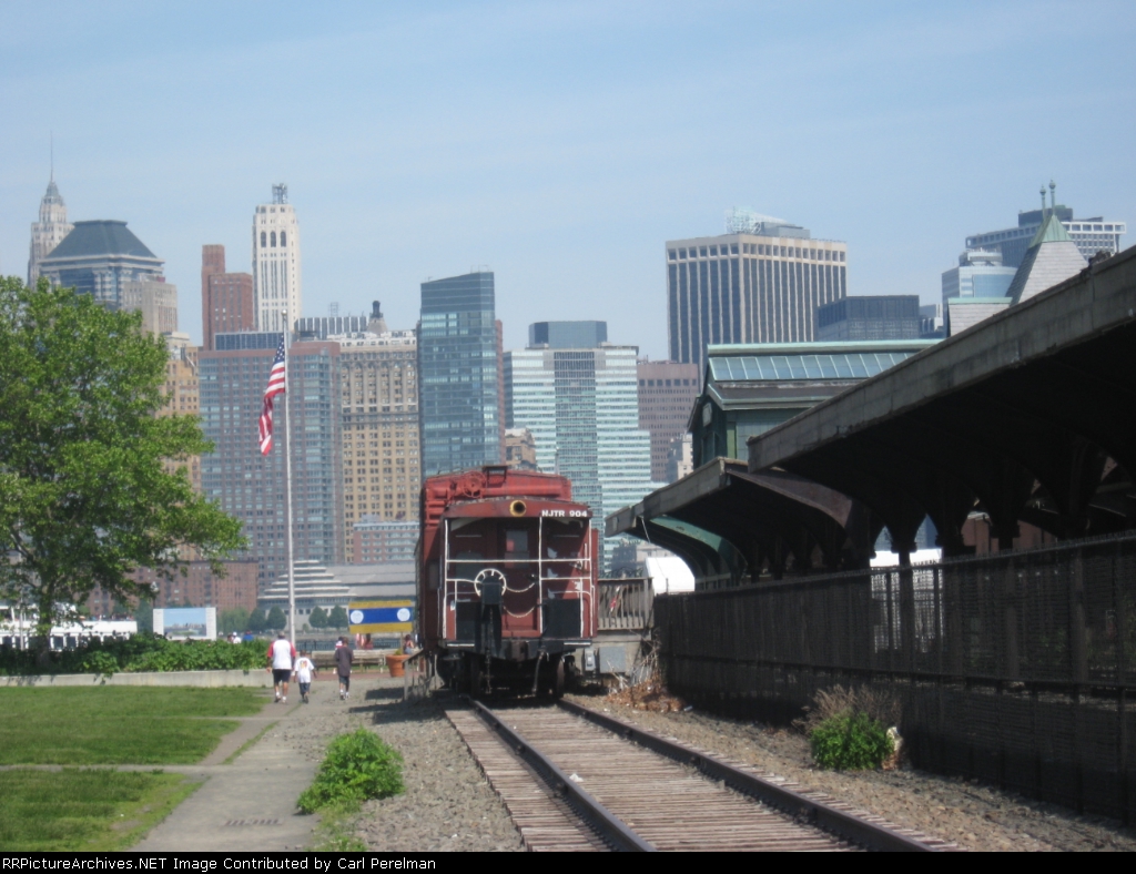 Ex NJ Transit bay windo caboose on display with New York Skyline