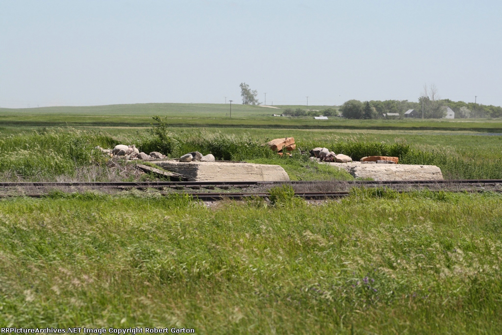 Unidentified Structure Foundation Next to a Decaying Siding