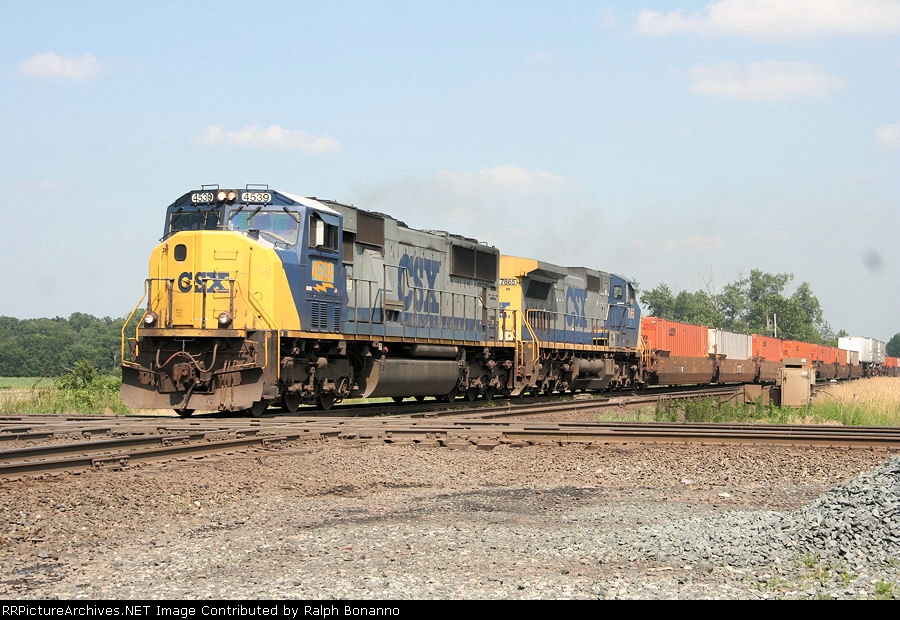 Intermodal train Q135 heads across the diamonds into the afternoon sun
