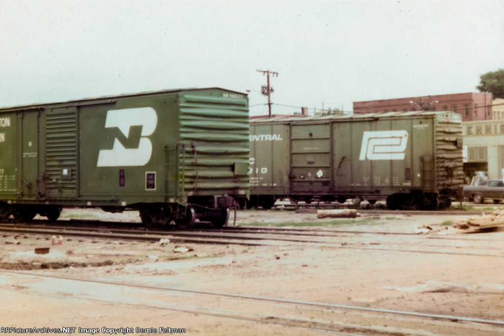 Foreign line box cars from Burlington Northern and Penn Central sit on the Western Railway of Alabama tracks east of the depot awaiting placement on customer sidings