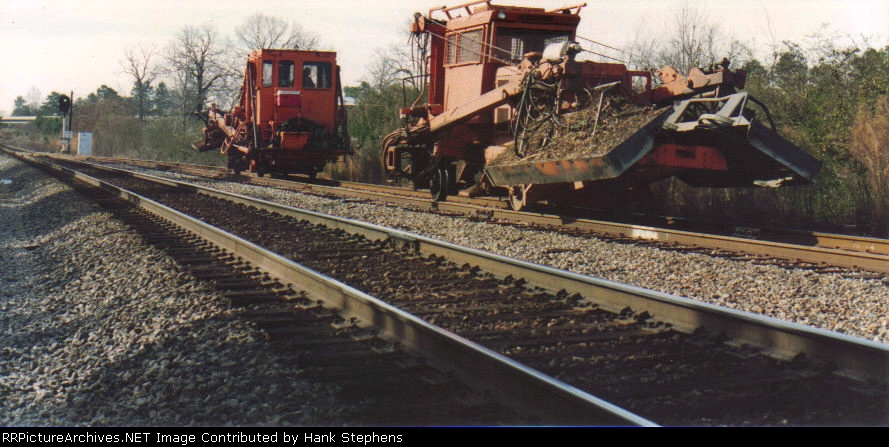 STAND CLEAR--On-Track brushcutters follow the Turn through the junction.  The heavy duty blades destroy what they cannot cut, and woe be unto the passerby that gets close enough to be hit by flying tree trunks!