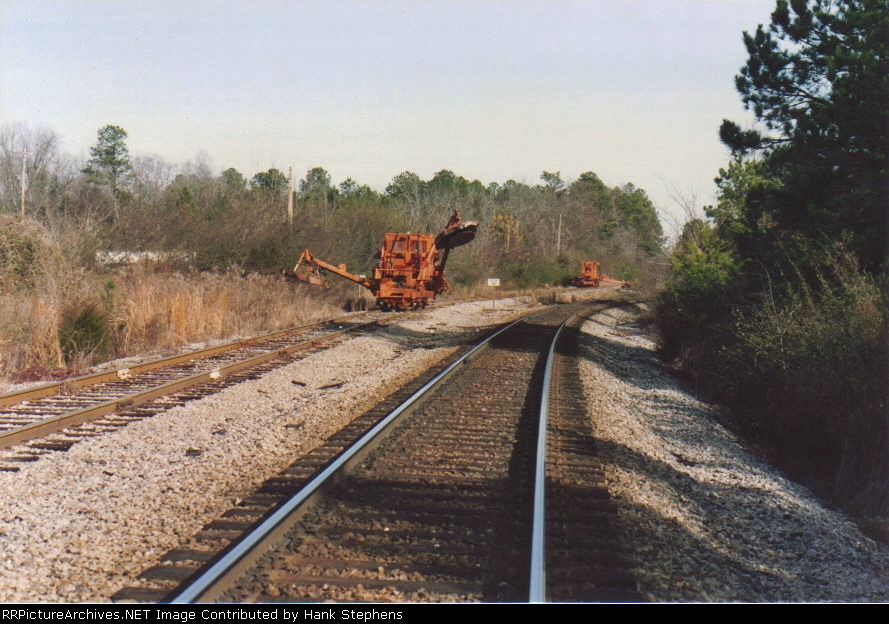Time to get down to business--On-track brushcutters unfold their arms and start cleaning off overgrowth on the Johhny Ray line to LaFayette, AL