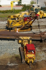 2 RJ Corman Cats Work on Rerailing Flatcar